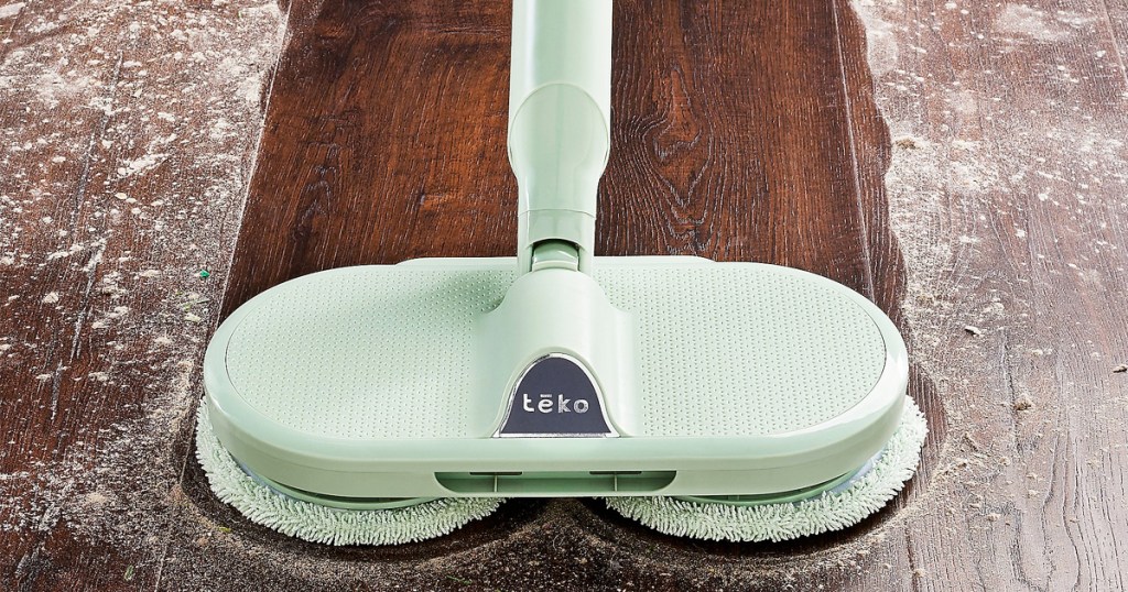 mint green scrub mop on wood floor