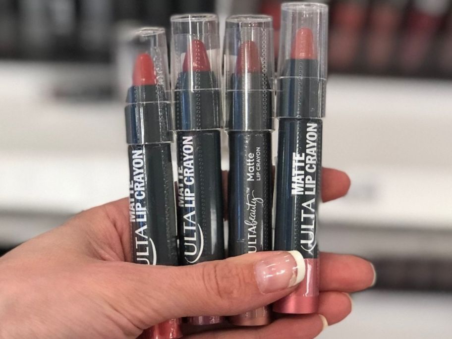 hand holding 4 Ulta Beauty Collection Matte Lip Crayons