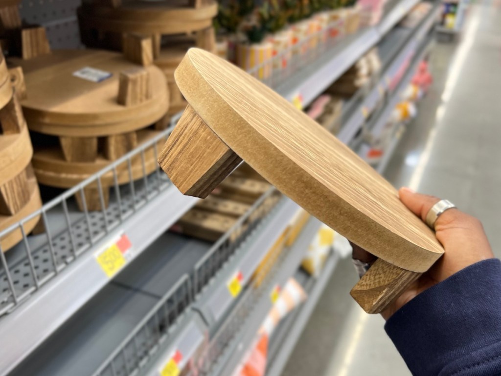 Woman holding wooden riser