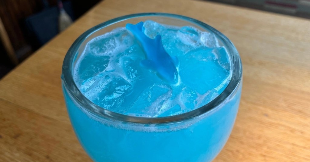 blue cocktail garnished with gummy shark