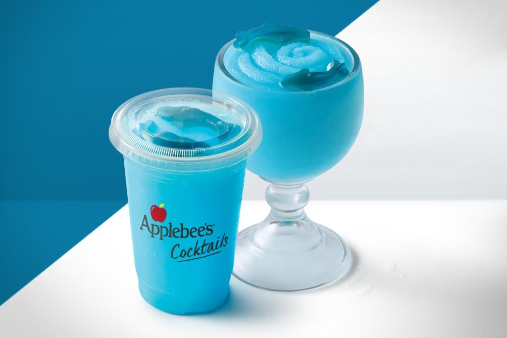 2 blue frozen drinks garnished with gummy sharks