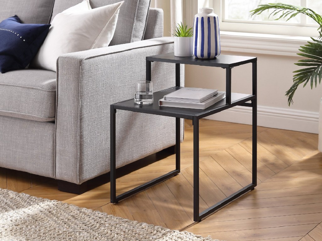 black metal and wood side table next to couch