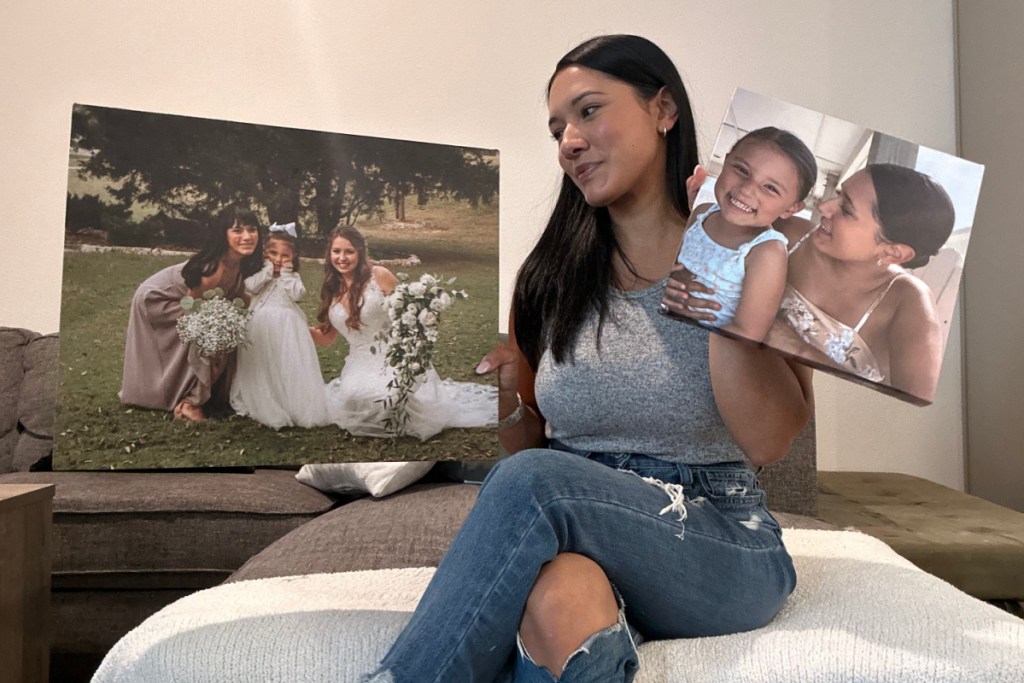 woman holding two canvases in hands