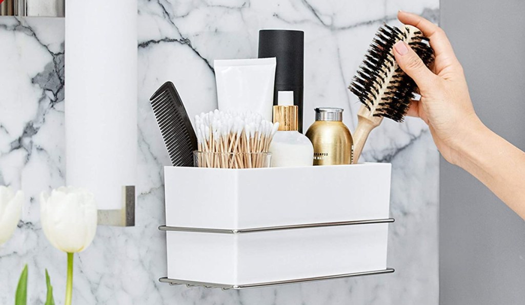 command organizing bin with items and hand pulling it out