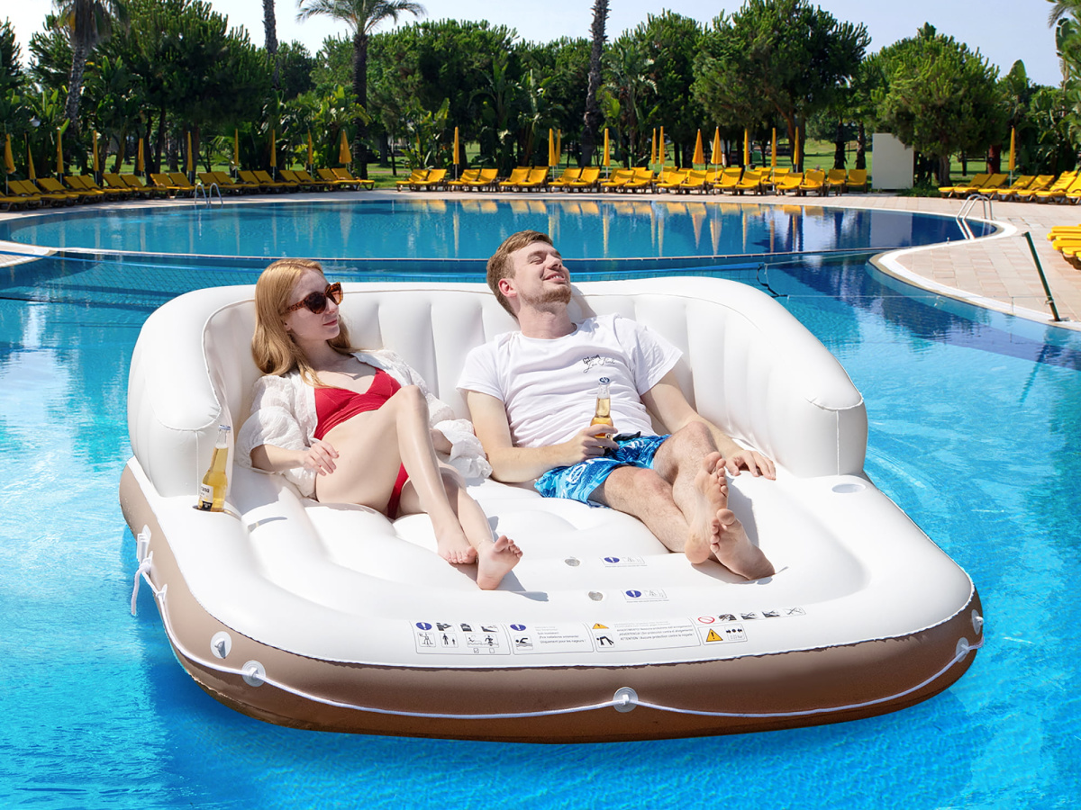 two people in a costway pool float with canopy off
