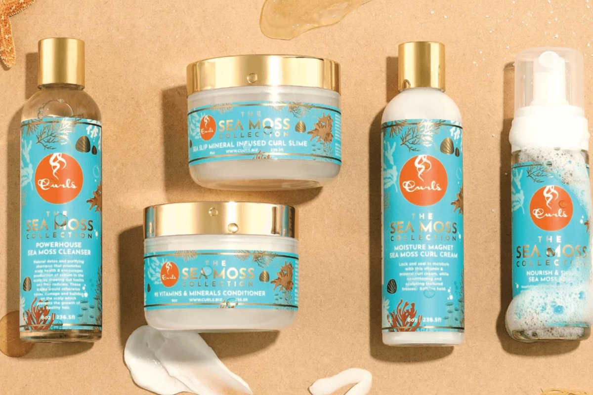 botltles of curls sea moss on sand 