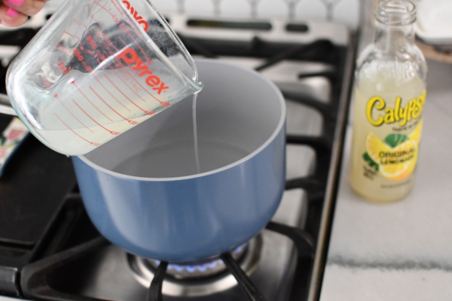 heating up water and lemonade on the stove