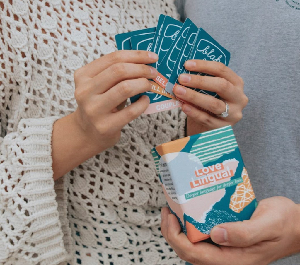 couple holding love lingual cards and box