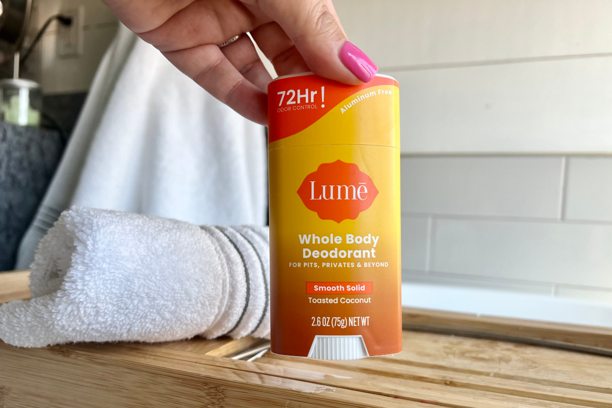 hand grabbing Lume stick deodorant