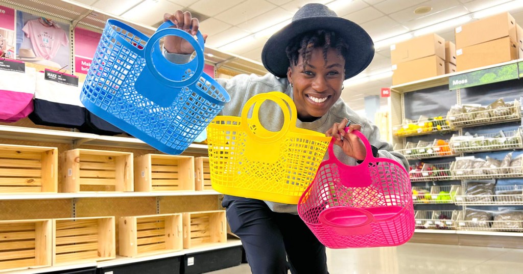 woman holding blue, yellow and pink jelly totes in Michaels store