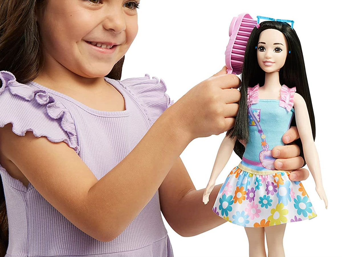 girl playing with my first barbie renee doll