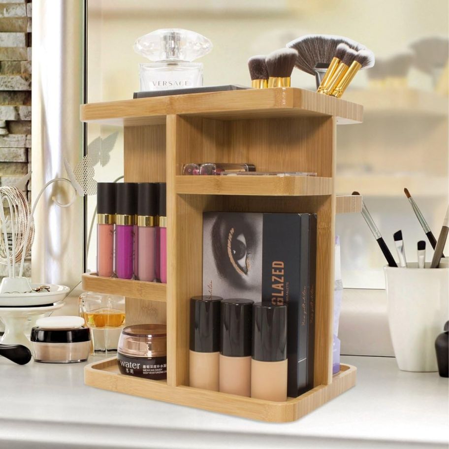 rotating bamboo makeup organizer on a bathroom counter