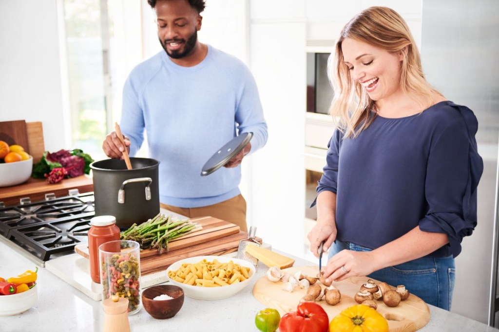 man and woman cooking in kitchen