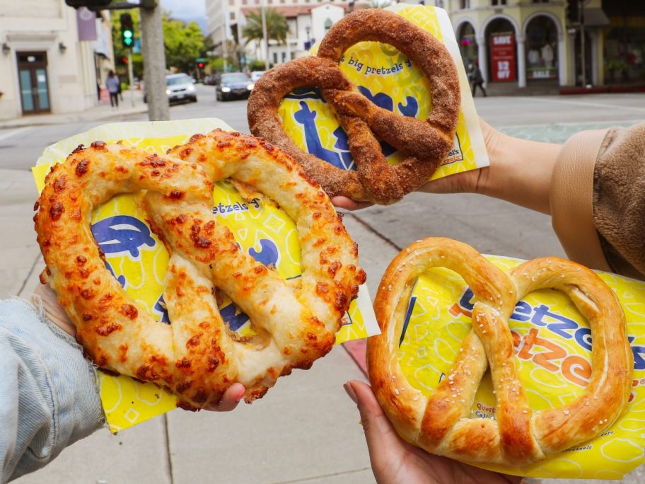 holding 3 Wetzel's Pretzels