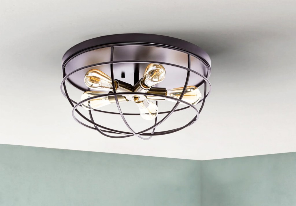 flush mount light on ceiling with brass cage detail
