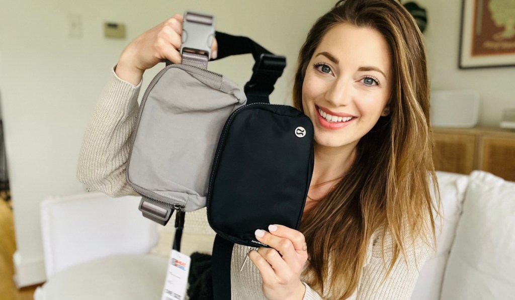 woman holding up 2 32 degrees belt bags