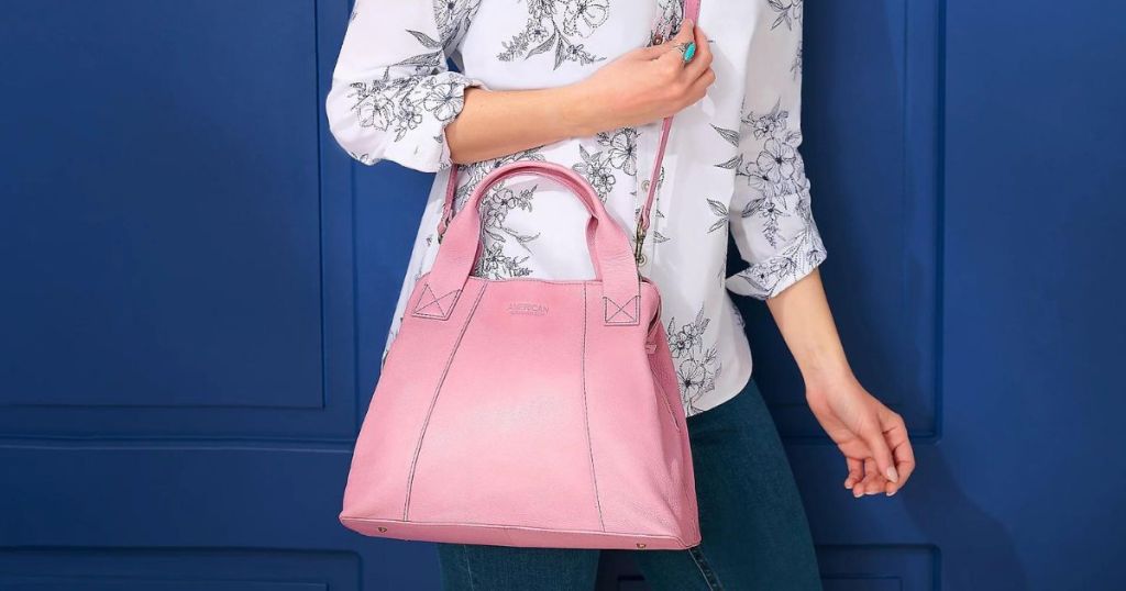 person with pink leather satchel swung across chest