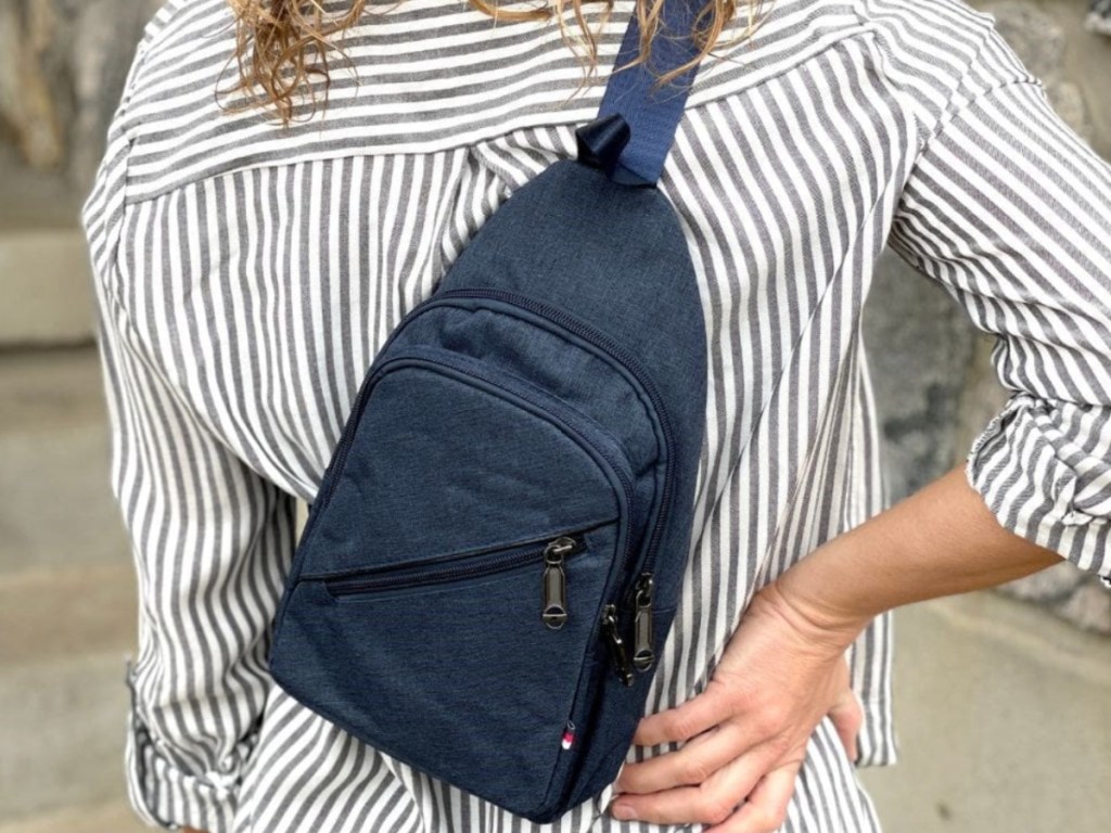 woman wearing Blue Sling Bag across back of body