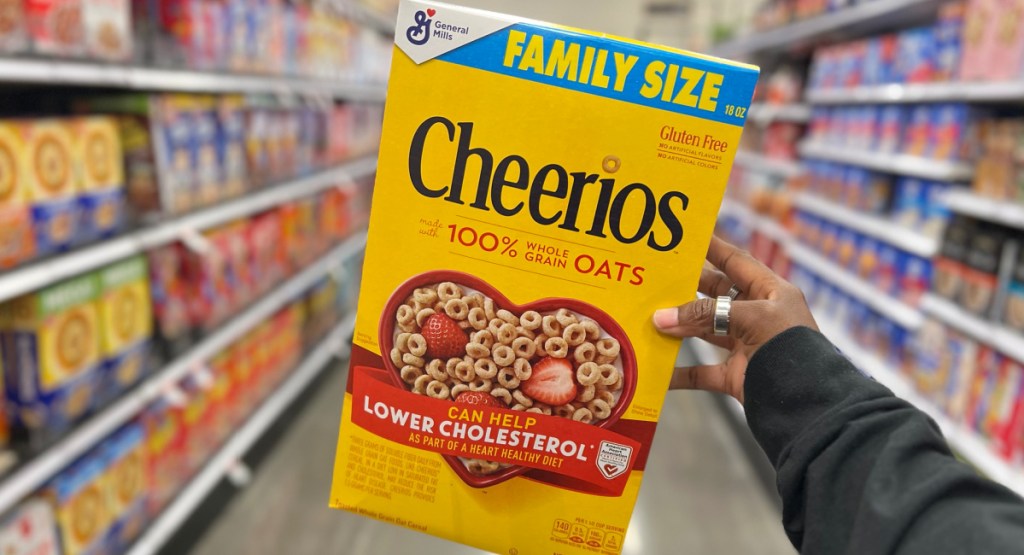 Cheerios family size box in woman's hands at store