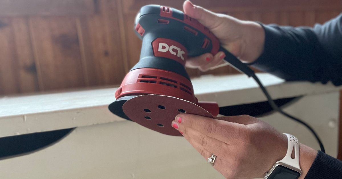 person putting blade on DCK sander