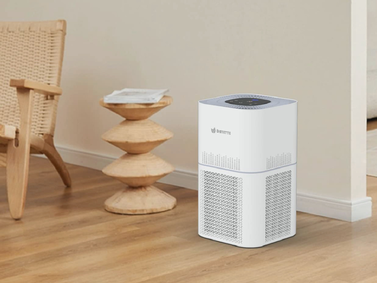 Air purifier next to chair and stand