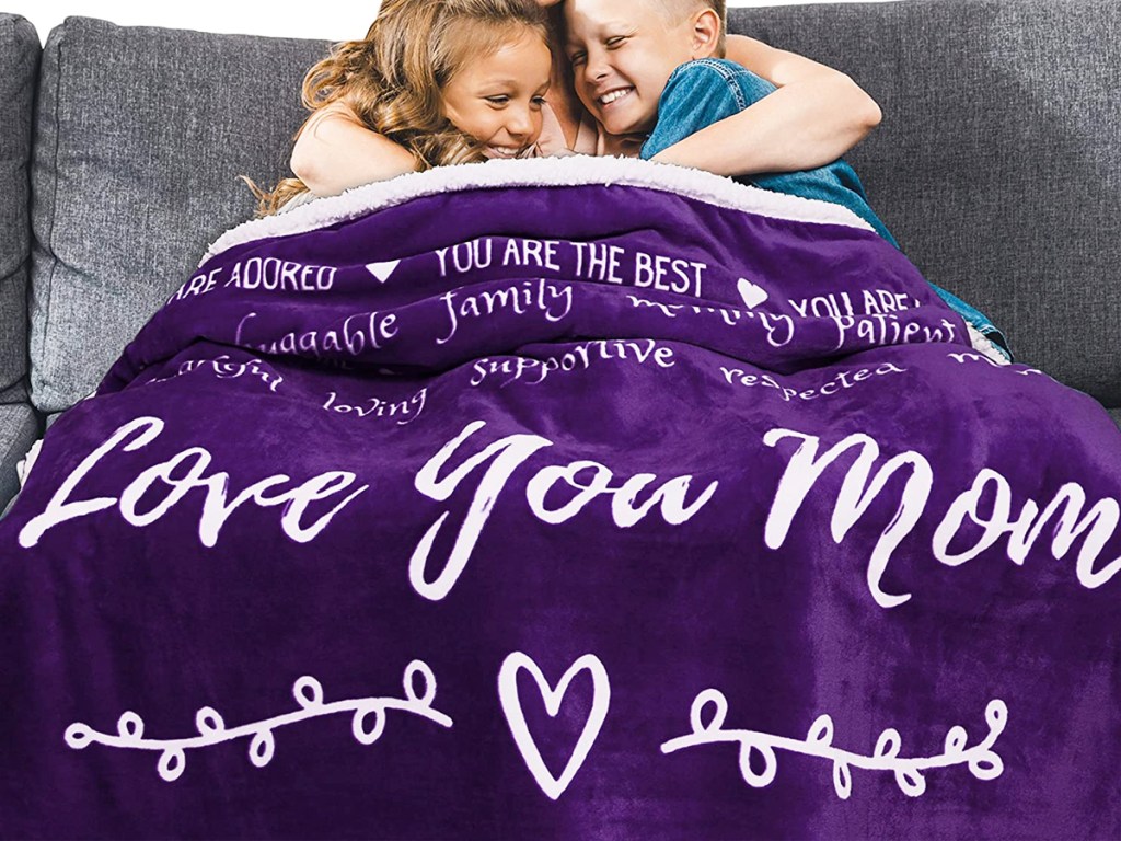 kids under a purple mother's day fleece blanket