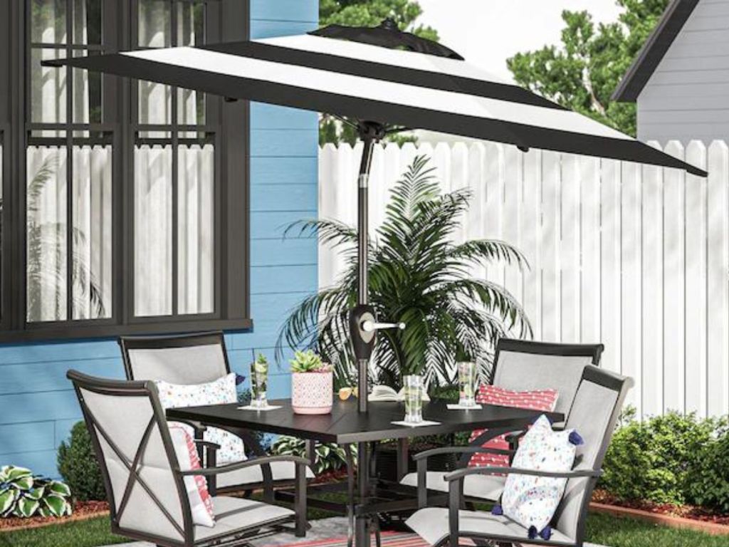 Patio table with Allen & Roth black & white striped tilted patio umbrella