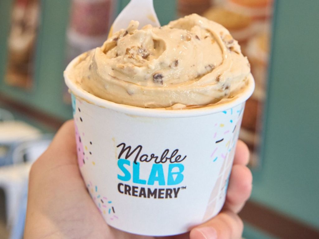 hand holding a cup of Marble Slab Creamery Ice Cream