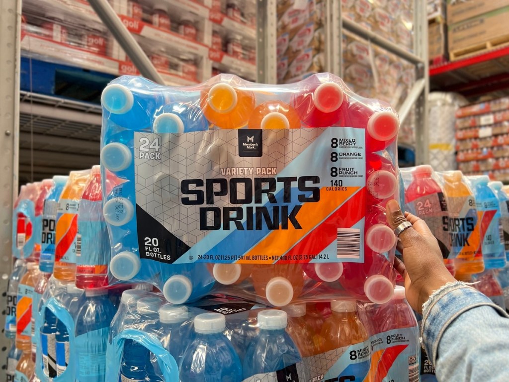 holding a case of sports drink on its side