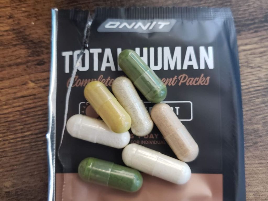 ONNIT Total Human Packet with pills laying on top of it