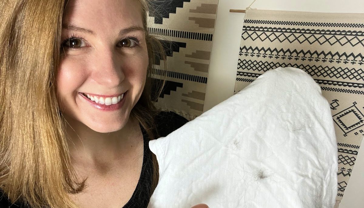 Woman pointing at dog hair on her tshirt