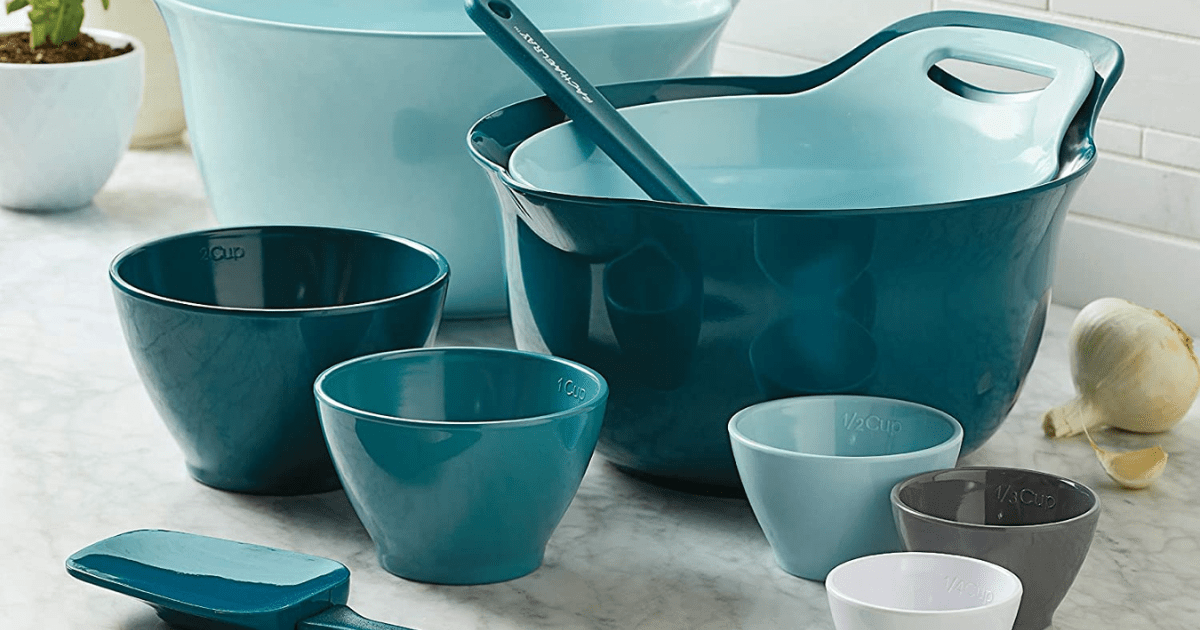 3 big blue mixings bowls with a hand and spout, and 5 smaller mixing bows and 2 spatulas on counter