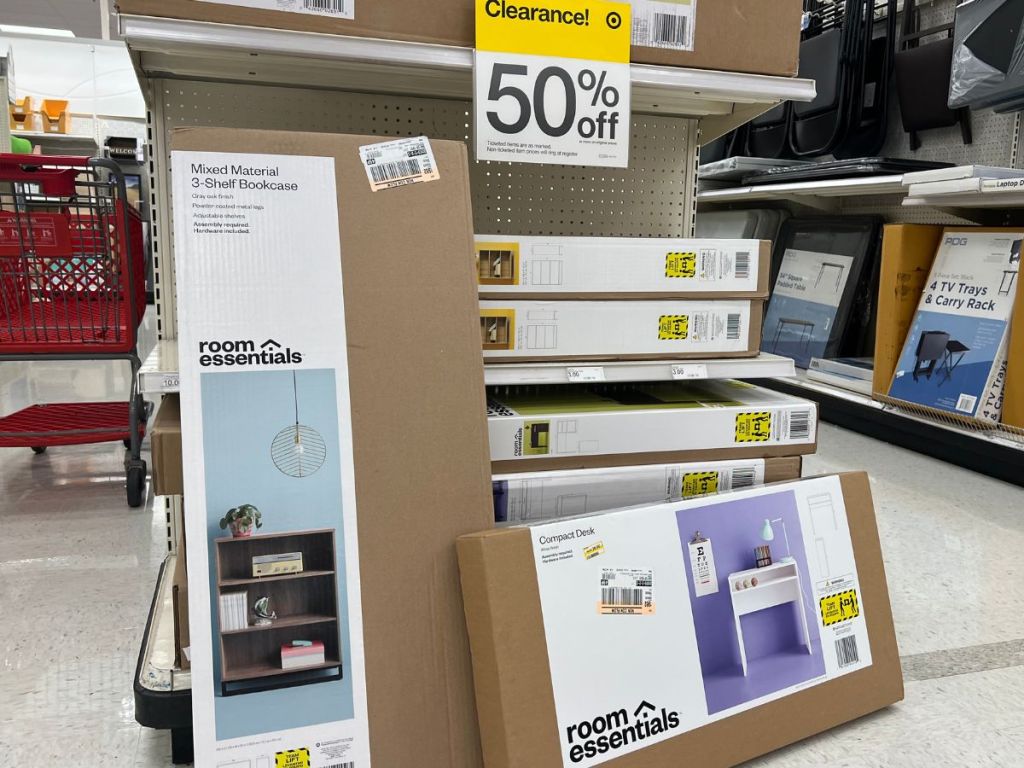 Two Room Essentials Desks boxes leaning against a shelf at Target