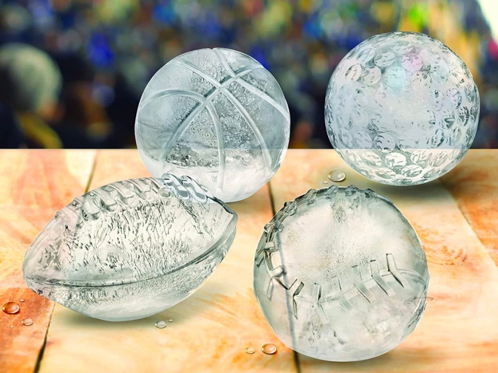 four different sports balls molded in ice