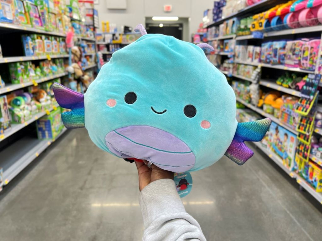 Hand holding a dragonfly squishmallow