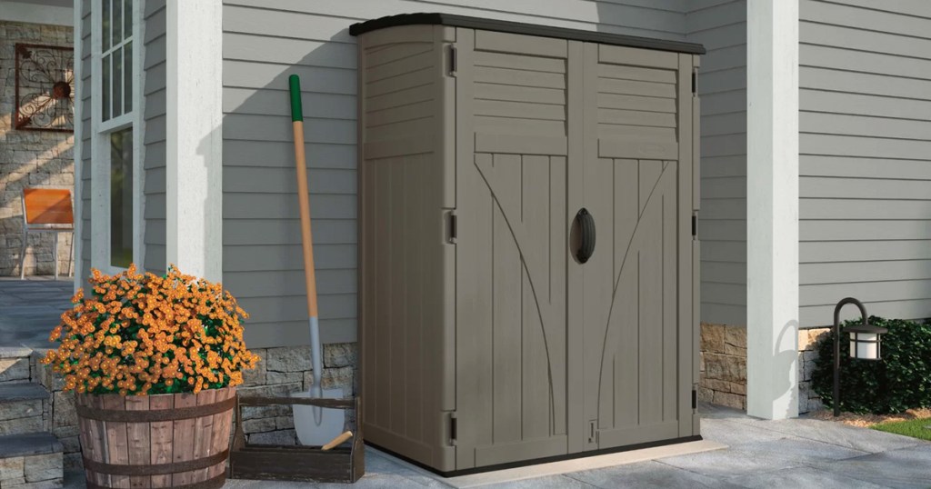 tall brown storage shed next to a house