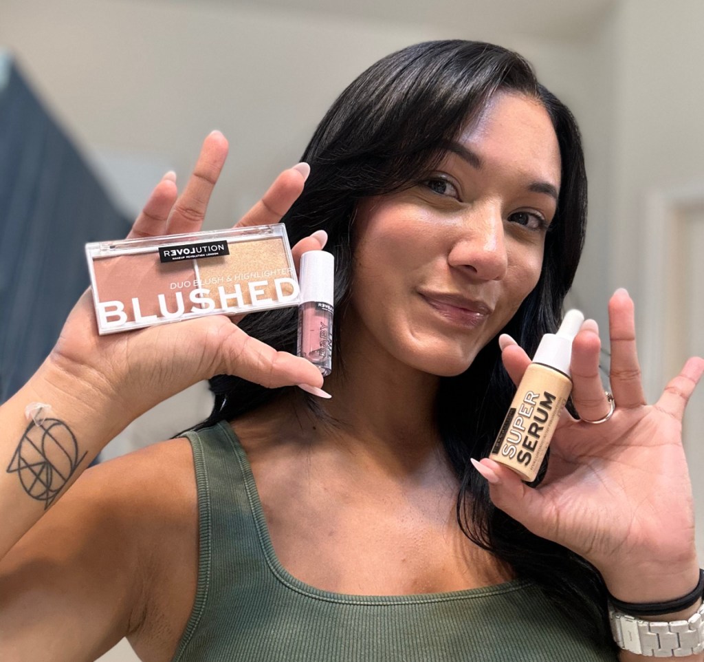 Woman holding several bottles of cheap makeup from Walmart