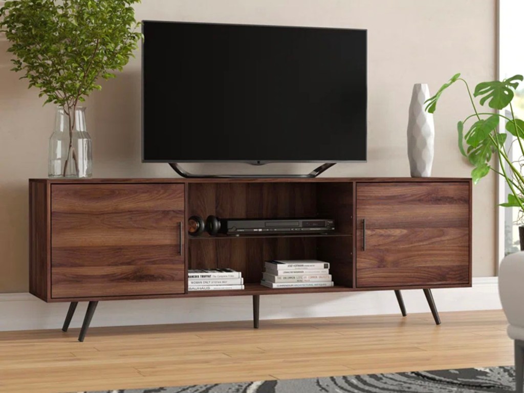 dark brown tv stand with tv sitting on it in living room