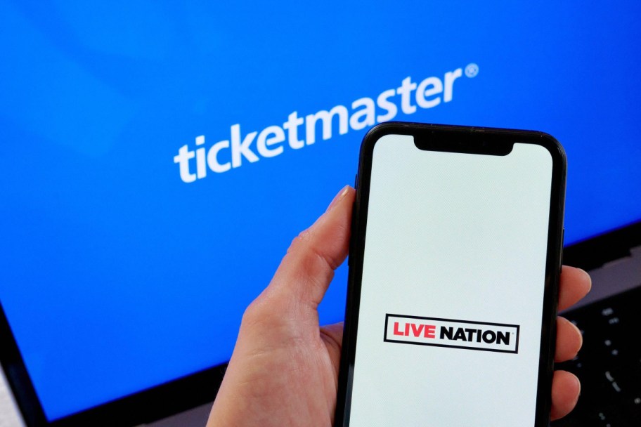 hand holding phone with live nation in front of ticketmaster screen
