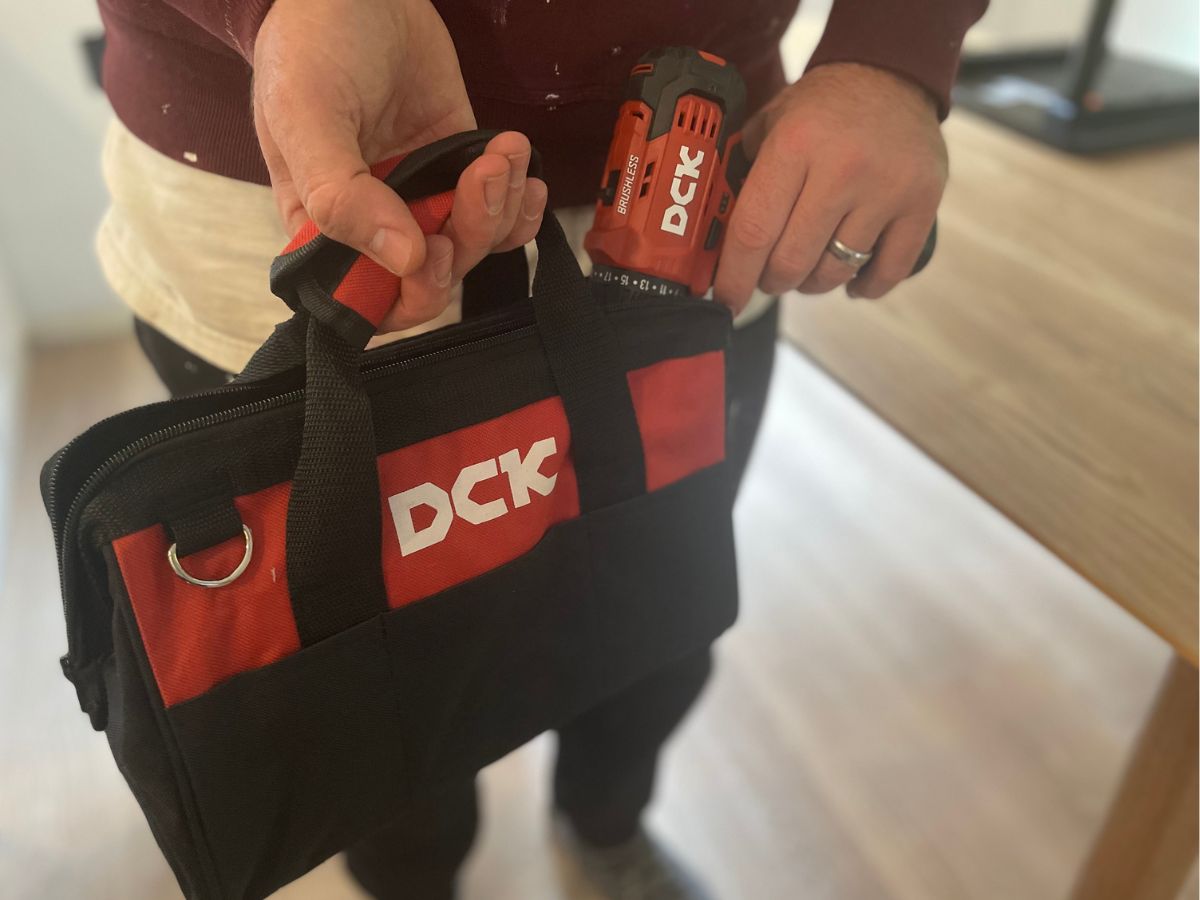 person holding DCK tool bag and DCK drill