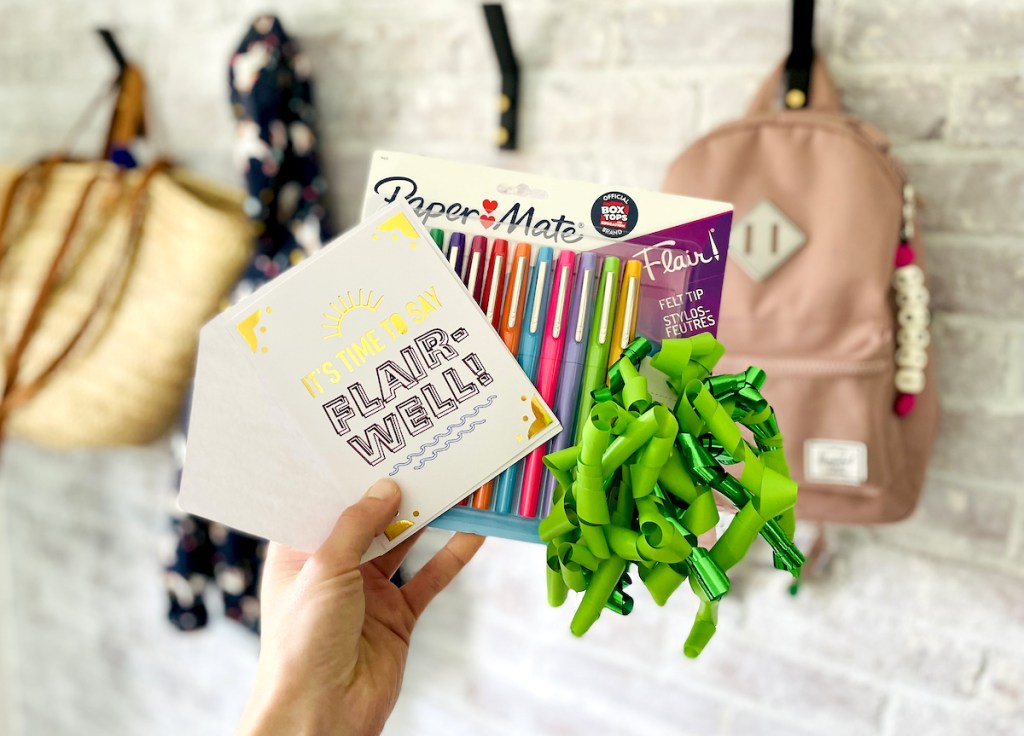 hand holding a pack of flair pens and cards with bow for diy teacher gifts