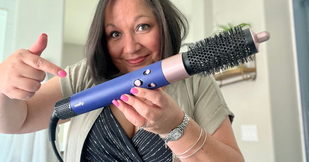 woman holding blue dyson airwrap