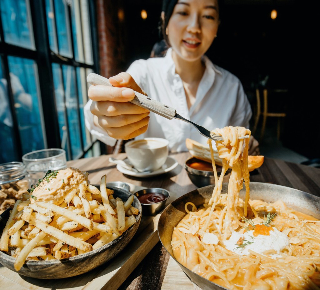 woman eating noodles at one of the Groupon restaurants