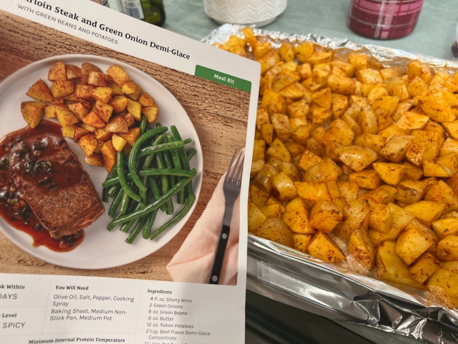 sheet pan full of potatoes next to recipe card