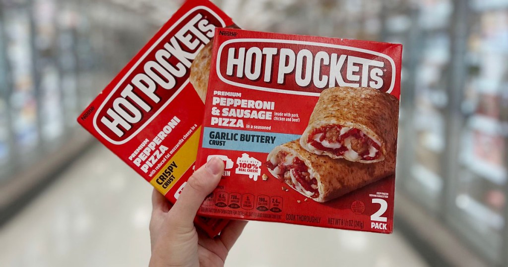 hand holding two hot pocket boxes