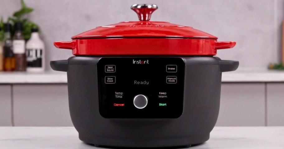 a black and red Instant Pot Dutch Oven on a kitchen counter