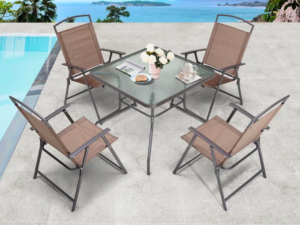 square glass table with 4 folding brown chairs