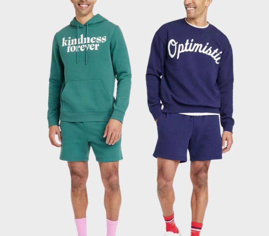 two men wearing sweatshirts and shorts stock image