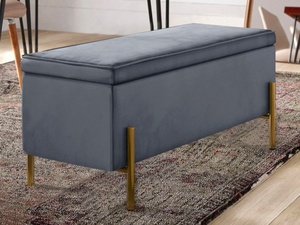 gray bench with gold legs sitting on gray rug