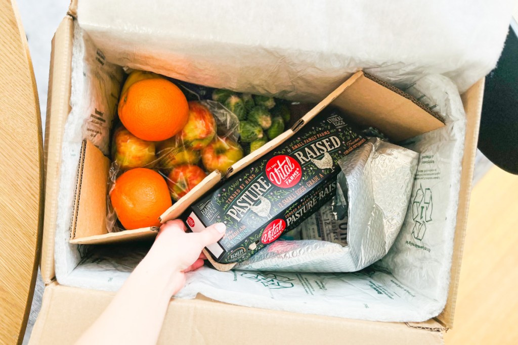 hand unpacking misfits market box